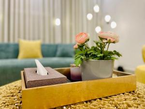 a living room with a table with flowers on it at Spacious new 2 bedroom Apt-in amazing location B9 in Riyadh