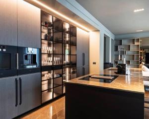a kitchen with a refrigerator and a counter top at Karl Penthouse in Rostock