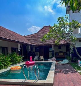a swimming pool in the backyard of a house at Ndalem Srigading Villa Solo Entire Villa in Bonorejo