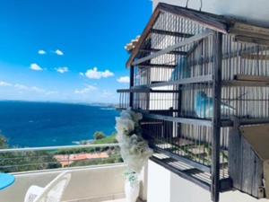 a balcony with a view of the ocean at Villa Daisy in Terra Mala +2 photos