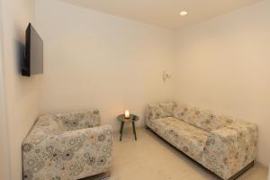 a living room with two couches and a candle on a table at Ponte di Cecco appartamenti in Ascoli Piceno