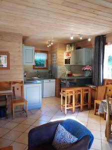 a kitchen with white cabinets and a table and chairs at Chalet Deleglise 1 in Valfréjus