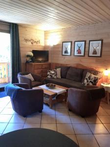 a living room with a couch and a table at Chalet Deleglise 1 in Valfréjus