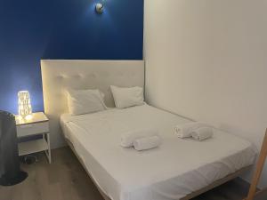 a white bed with two pillows on top of it at Maryland Terrace by RPG Properties in Albufeira +7 photos