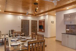 a dining room with a long table and chairs at 2 Bhk l Kasauli l Kasauli Home l Serviced Apartments in Kasauli