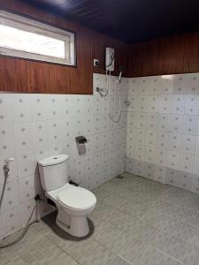 a bathroom with a toilet and a shower at CRAB and STAY in Nuwara Eliya