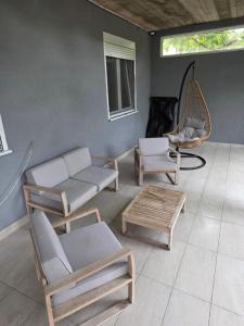 a living room with chairs and a couch and a table at Guest house Danica in Bar