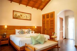 a bedroom with a bed and a bench in a room at The Jam Boutique Hotel in Luang Prabang +98 photos