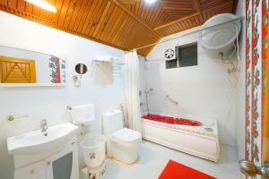 a bathroom with a toilet and a sink at Hotel Lily Woods, Near JW Marriott Mussoorie - A Beautiful Lavish & Luxury Hotel with Mountain View Managed By Lily in Mussoorie
