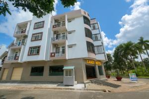 a white building with a sign in front of it at Candy Hotel Can Tho in Cái Răng +49 photos