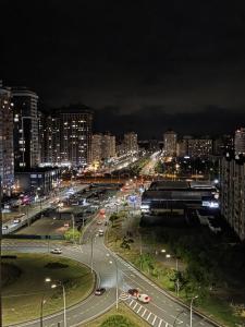 a city at night with traffic on a highway at The pearl of the city with a great view of the whole Kyiv in Kyiv