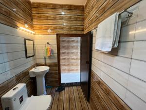a bathroom with a toilet and a sink at Ganga Valley Homestay in Chakrāta