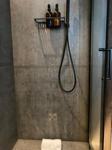 a shower with two bottles on a rack in a bathroom at Hunters Cabin - Rustic farm stay in Great Chart