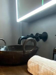 a bathroom with a copper sink in a room at Hunters Cabin - Rustic farm stay in Great Chart +10 photos