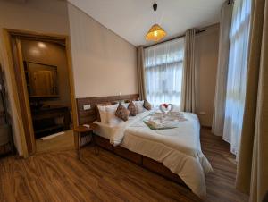 a hotel room with a bed and a window at Explorers Kilimanjaro Boutique Hotel in Moshi