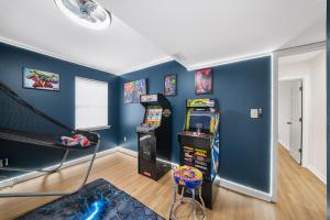 a room with a pinball machine and a slide at The Hidden Oasis! Minutes to dwntwn and ATL airpt! in Jonesboro