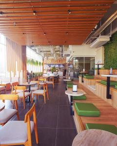 a restaurant with tables and chairs and people in the background at High-Rise Studio in Elysium Opp Centaurus in Islamabad
