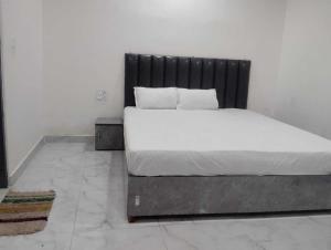 a bed with a black headboard in a room at Hotel O N P Grand and Resort in Manwān