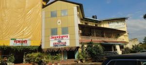 a building with signs on the side of it at Hotel O Kumar's Amantran Lodging in Manor +1 photo