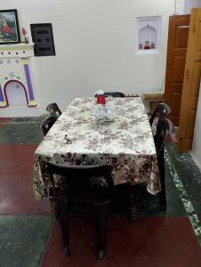 a table in a room with a table cloth on it at Topper home stay in Varanasi