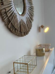 a mirror on a wall next to a table at T2, 50 m beach, balcony with sea view in La Teste-de-Buch