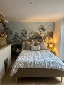Un dormitorio con una cama con un cuadro en la pared. en Cottage on high street, own parking and EV charger, en Chipping Norton