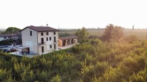 an aerial view of a house in a field at Corte Bottura agriturismo in Castelnuovo del Garda