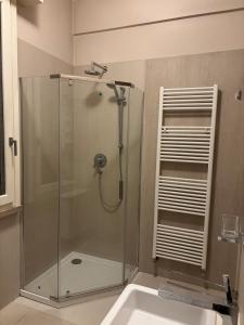 a glass shower in a bathroom with a sink at Holiday Home Parma in Parma