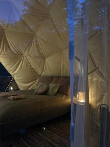 a bedroom with a bed in a tent at River Camp in Lembuži +50 photos