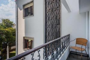 a chair sitting on the balcony of a house at AC House in Porto