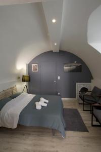 a bedroom with a bed with two towels on it at Studio Relaxe in Jougne