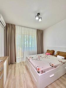Un dormitorio con una cama y una ventana grande. en IN APART HOTEL, en Bucarest