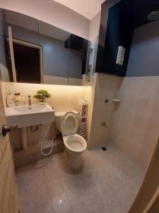 a small bathroom with a toilet and a sink at Budget Hotel in West Service in Manila