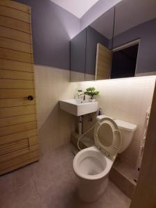 a bathroom with a toilet and a sink at Budget Hotel in West Service in Manila
