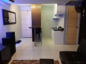 a kitchen and a living room with a table and a counter at Budget Hotel in West Service in Manila +3 photos