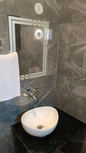 a white sink on a black counter in a bathroom at Hotel The Grand Elite Ramayan - Near Ram Mandir in Ayodhya +17 photos