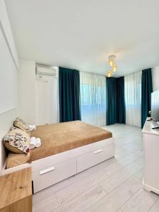 a bedroom with a large bed with two shoes on it at IN APART HOTEL in Bucharest