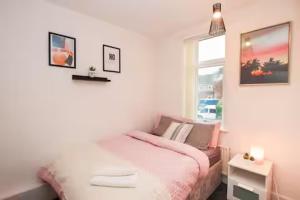 a small bedroom with a bed and a window at Entire 3-Bed Home Sheffield in Ecclesfield +11 photos