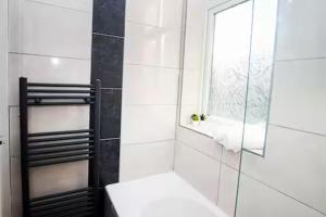 a bathroom with a toilet and a mirror at Entire 3-Bed Home Sheffield in Ecclesfield