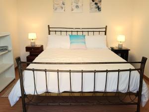 una camera da letto con un letto grande con due lampade di Adelaide's Cottage a Ponta do Pargo