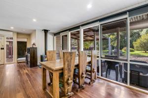 HeathcoteCarkeet Cottage的一间带桌子和大窗户的用餐室