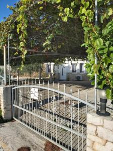 a white fence in front of a house at Little Seafront House Dolac Primošten in Dolac +18 photos