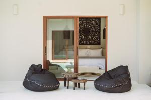 a bedroom with a bed and two bean bag chairs at Karma Shana Residence in Lamai