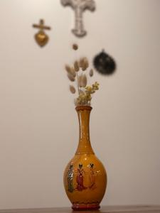 a yellow vase with flowers in it on a table at Mas de la Huppe - Franquevaux en Petite Camargue in Beauvoisin
