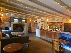 a bar in a restaurant with a couch and tables at Red Lion Inn in Newbrough