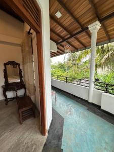 a house with a swimming pool and a balcony at Royal Resort in Weligama
