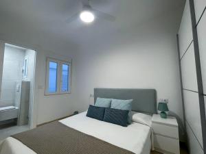a white bedroom with a bed and a window at 8th in Calpe, 200 meters from the beach in Calpe