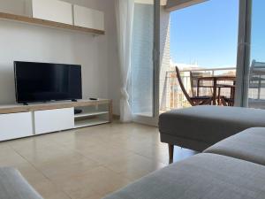 a living room with a flat screen tv and a couch at 8th in Calpe, 200 meters from the beach in Calpe