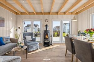 a living room with a wood stove in it at Ferienhaus Südheide Olpenitz in Olpenitz