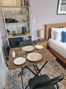 a room with a table and chairs and a bed at Sandy Paws in Portreath